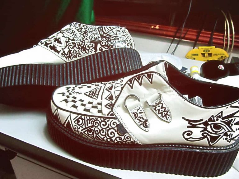 A pair of white brothel creepers with black detailing
